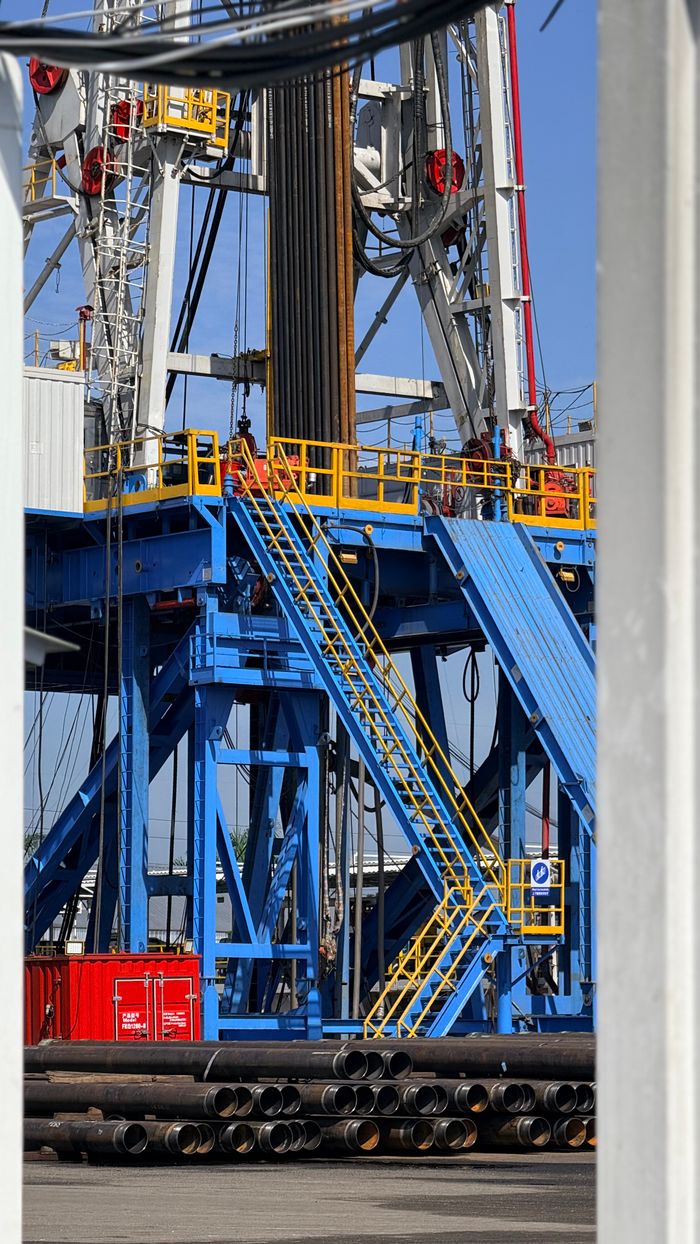 Vibrant blue drill rig structure in an industrial setting in Okoloma, Nigeria.