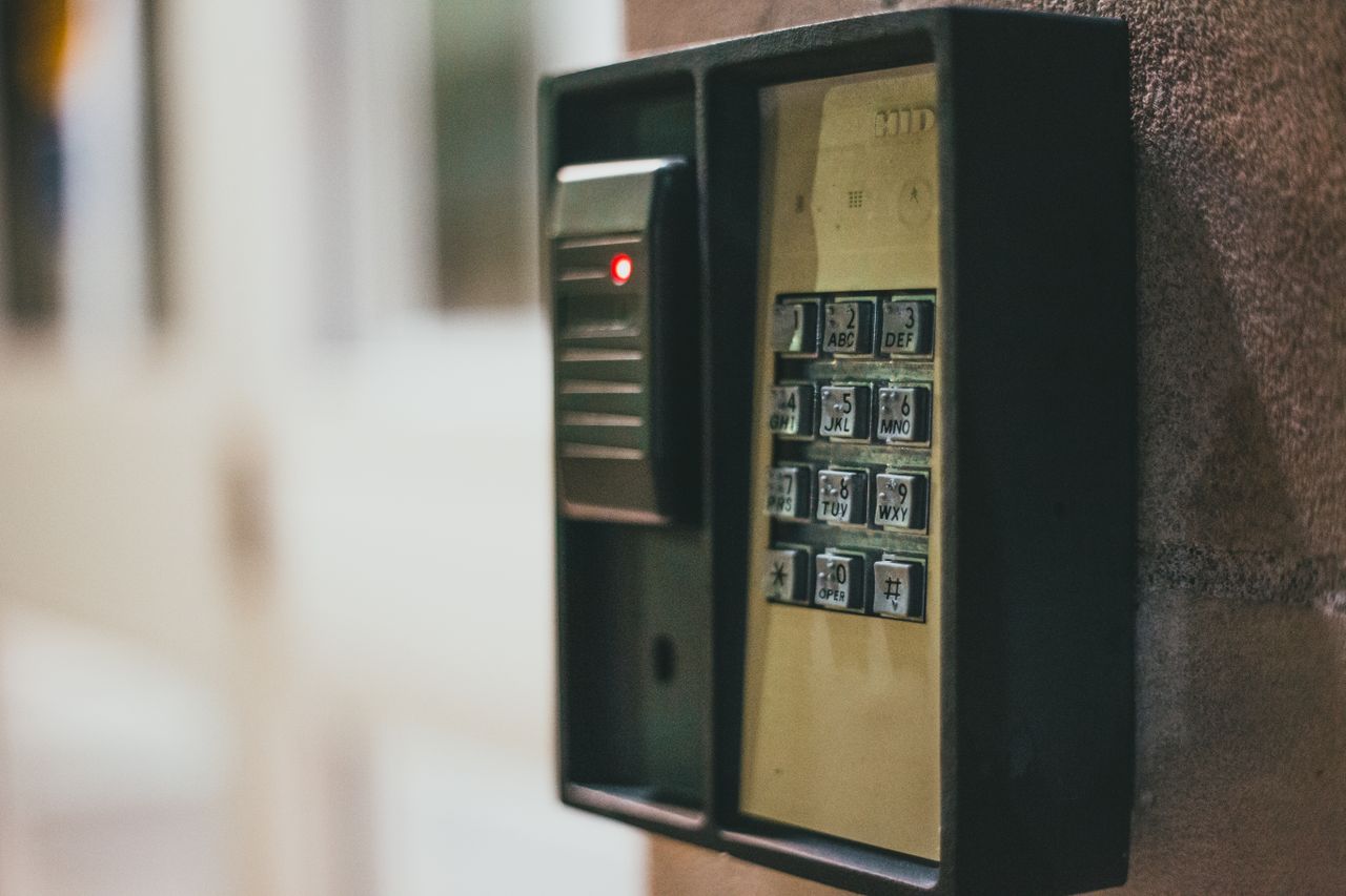Home Close-up of a security access control keypad with illuminated buttons for keyless entry.